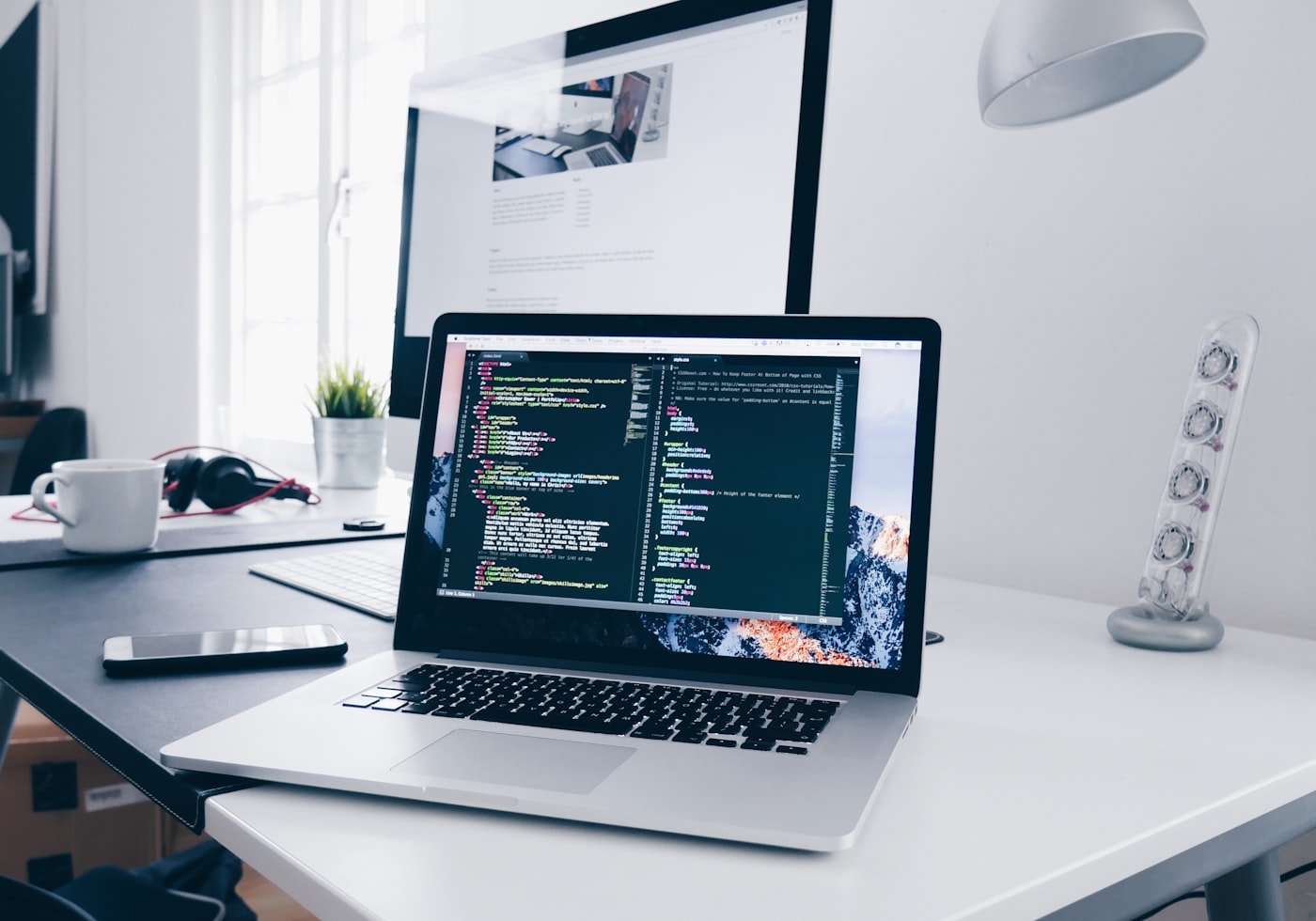Developer writing code for a website on a laptop